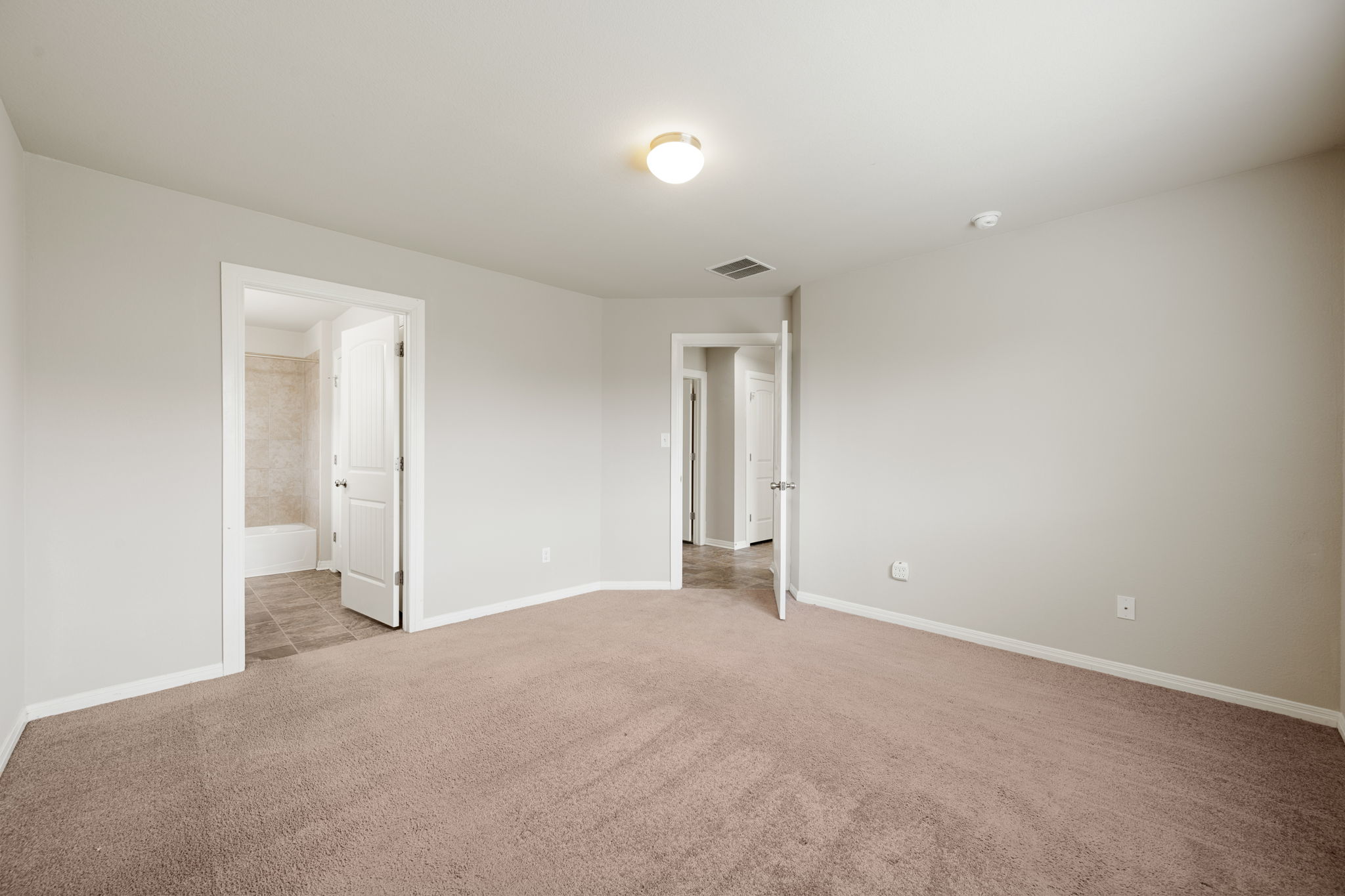 12701 Carillon Way Manor, TX 78653 - Photo 8 of 20 Carpeted room featuring neutral wall tones, white trim, and a flush-mount ceiling light