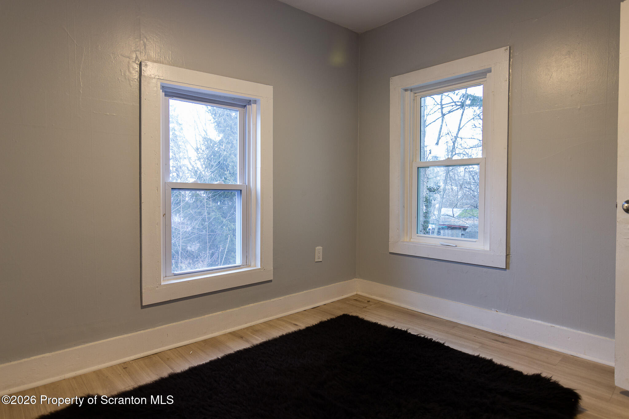 214 William Street Scranton, PA 18508 - Photo 20 of 33 a view of an empty room with wooden floor and a window