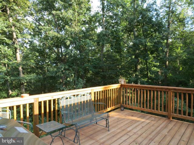 12622 Hilltop Road Lusby, MD 20657 - Photo 22 of 23 a view of balcony with wooden floor and fence