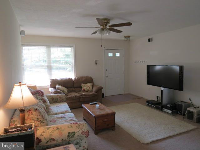 12622 Hilltop Road Lusby, MD 20657 - Photo 5 of 23 a living room with furniture and a flat screen tv