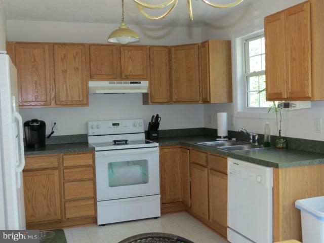 12622 Hilltop Road Lusby, MD 20657 - Photo 7 of 23 a kitchen with a stove a sink and a cabinets