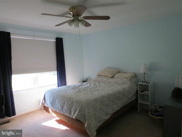 12622 Hilltop Road Lusby, MD 20657 - Photo 9 of 23 a bedroom with a bed and a window