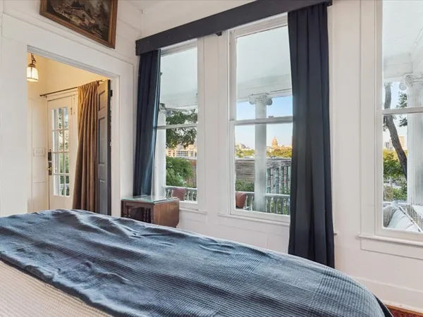 a bedroom with a bed and a large window