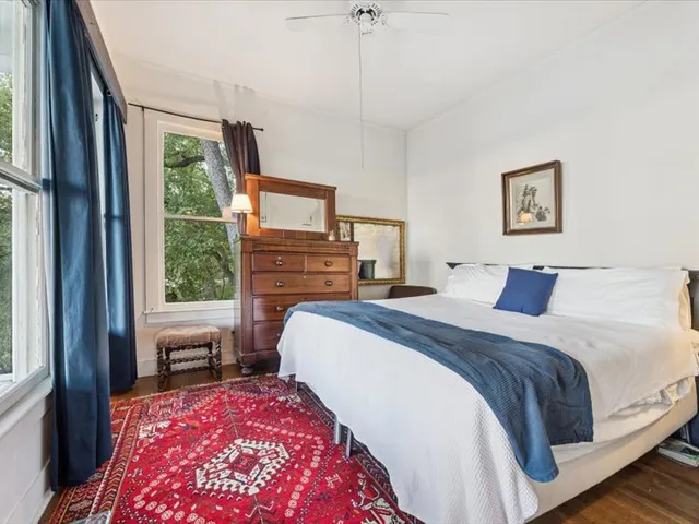 a bedroom with a large bed and a window