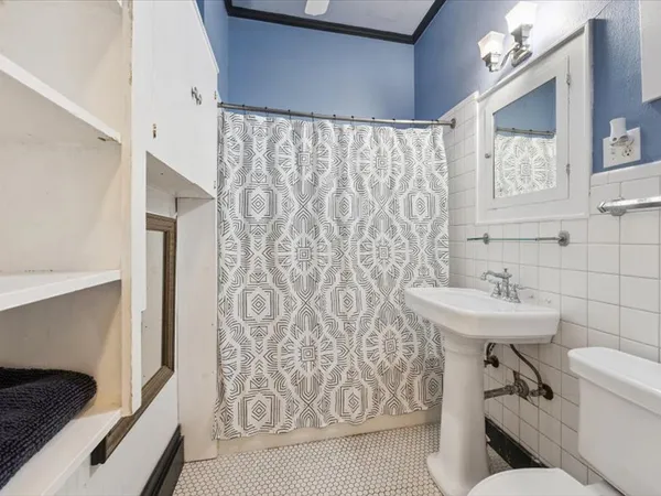 a bathroom with a sink and mirror with toilet