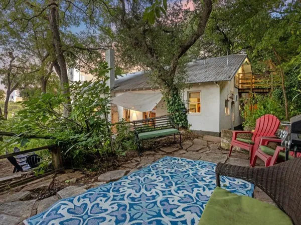a backyard of a house with outdoor seating