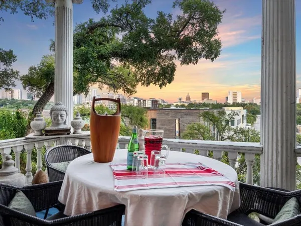 a view of a dining table and chairs in the balcony