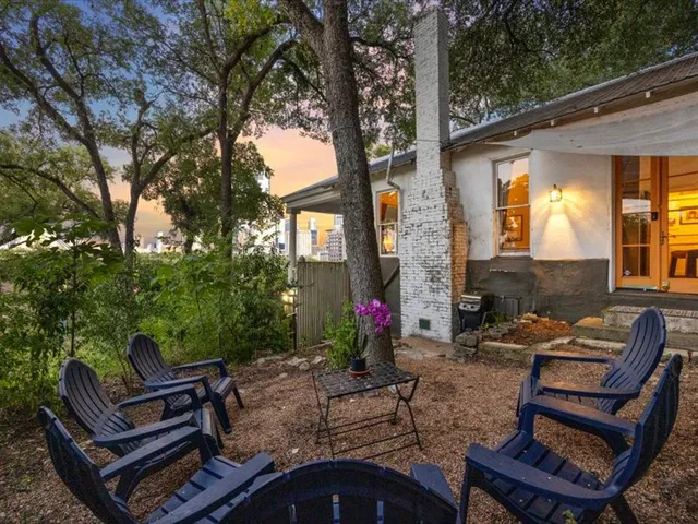 a view of a patio with couches table and chairs and potted plants