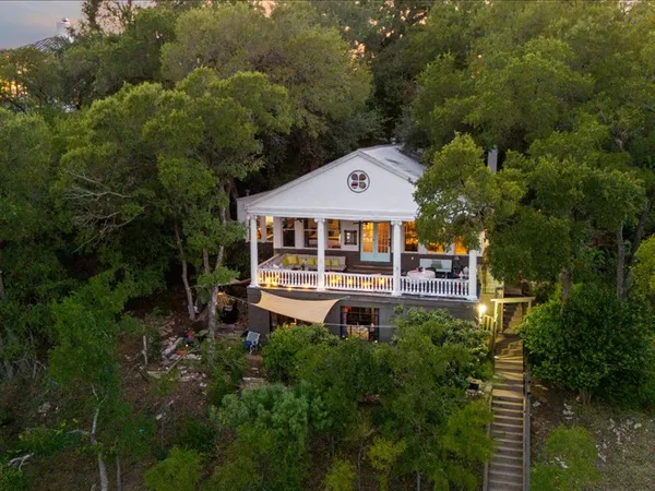 an aerial view of a house with swimming pool and garden