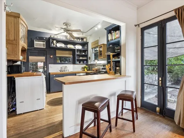 a kitchen with a table chairs sink and cabinets