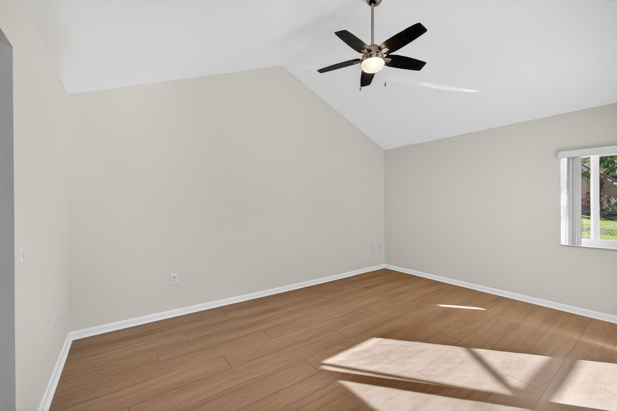 141 Cape Pointe Circle Jupiter, FL 33477 - Photo 13 of 31 an empty room with a window and a ceiling fan