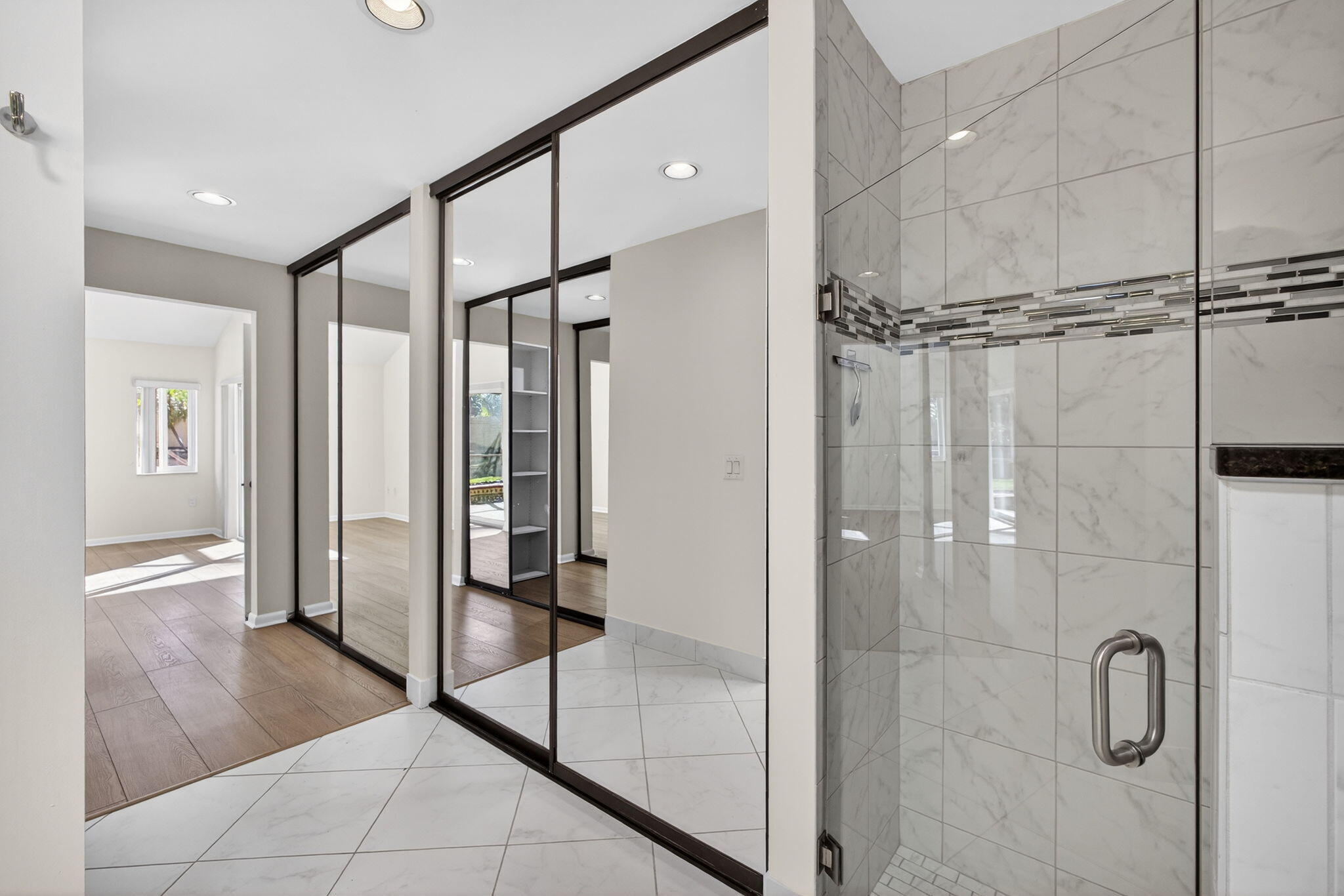 141 Cape Pointe Circle Jupiter, FL 33477 - Photo 16 of 31 a bathroom with a shower and a glass door