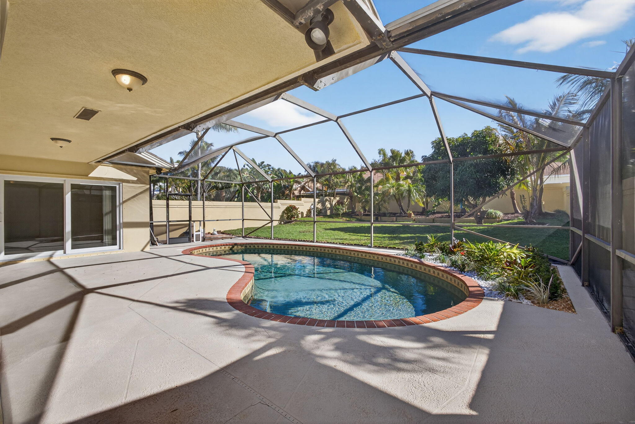 141 Cape Pointe Circle Jupiter, FL 33477 - Photo 2 of 31 a view of a backyard with sitting area