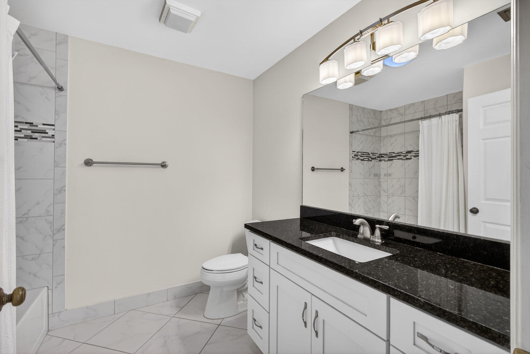 141 Cape Pointe Circle Jupiter, FL 33477 - Photo 22 of 31 a bathroom with a double vanity sink a toilet and a mirror