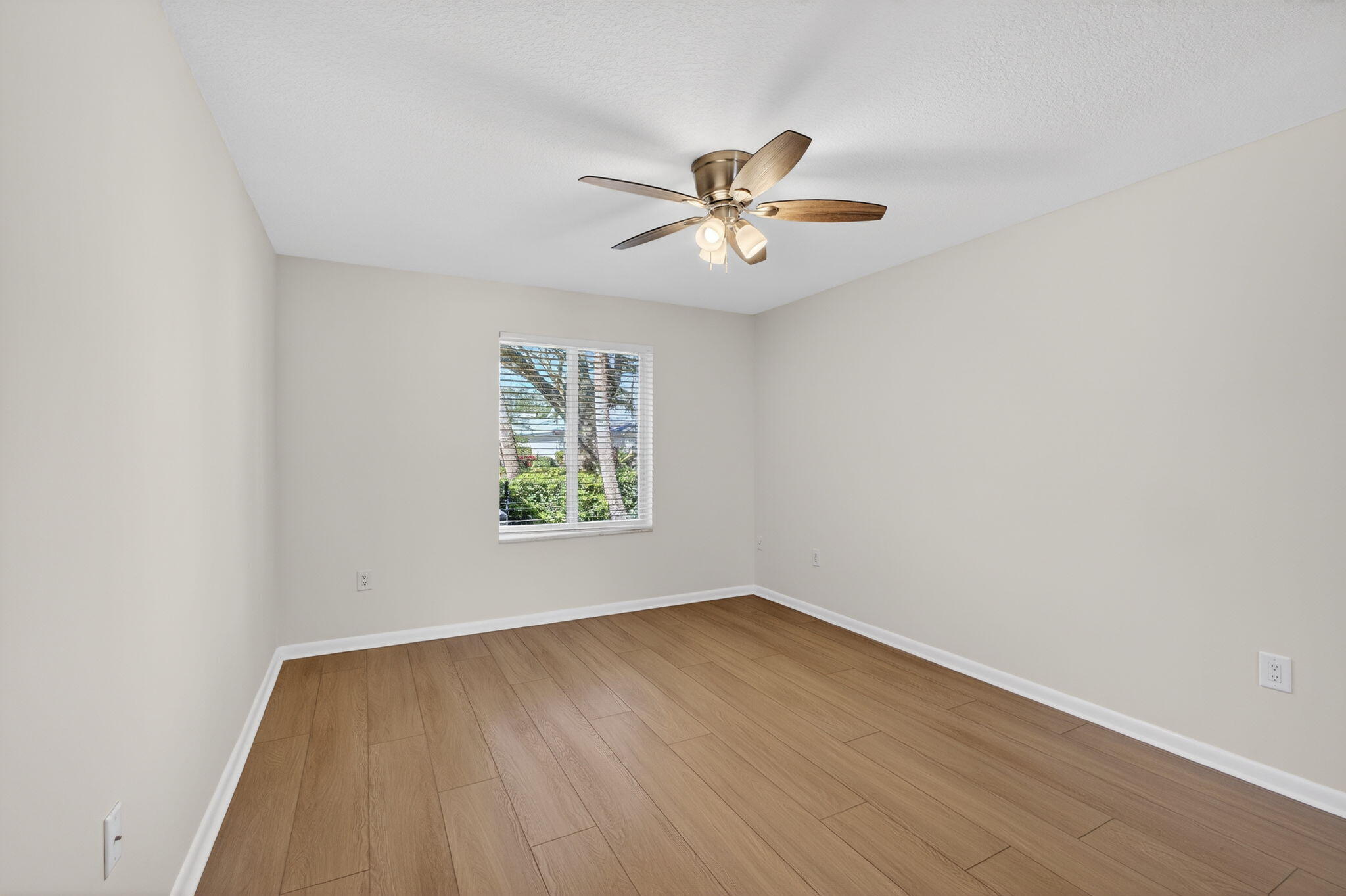 141 Cape Pointe Circle Jupiter, FL 33477 - Photo 24 of 31 a view of empty room with wooden floor and fan
