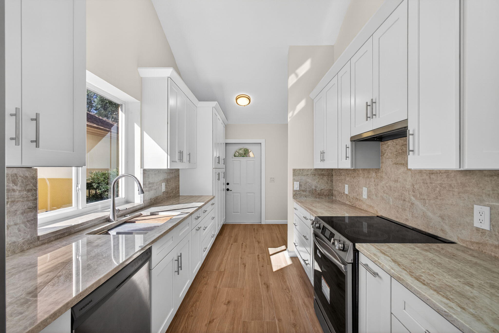 141 Cape Pointe Circle Jupiter, FL 33477 - Photo 5 of 31 a kitchen with a stove and a sink