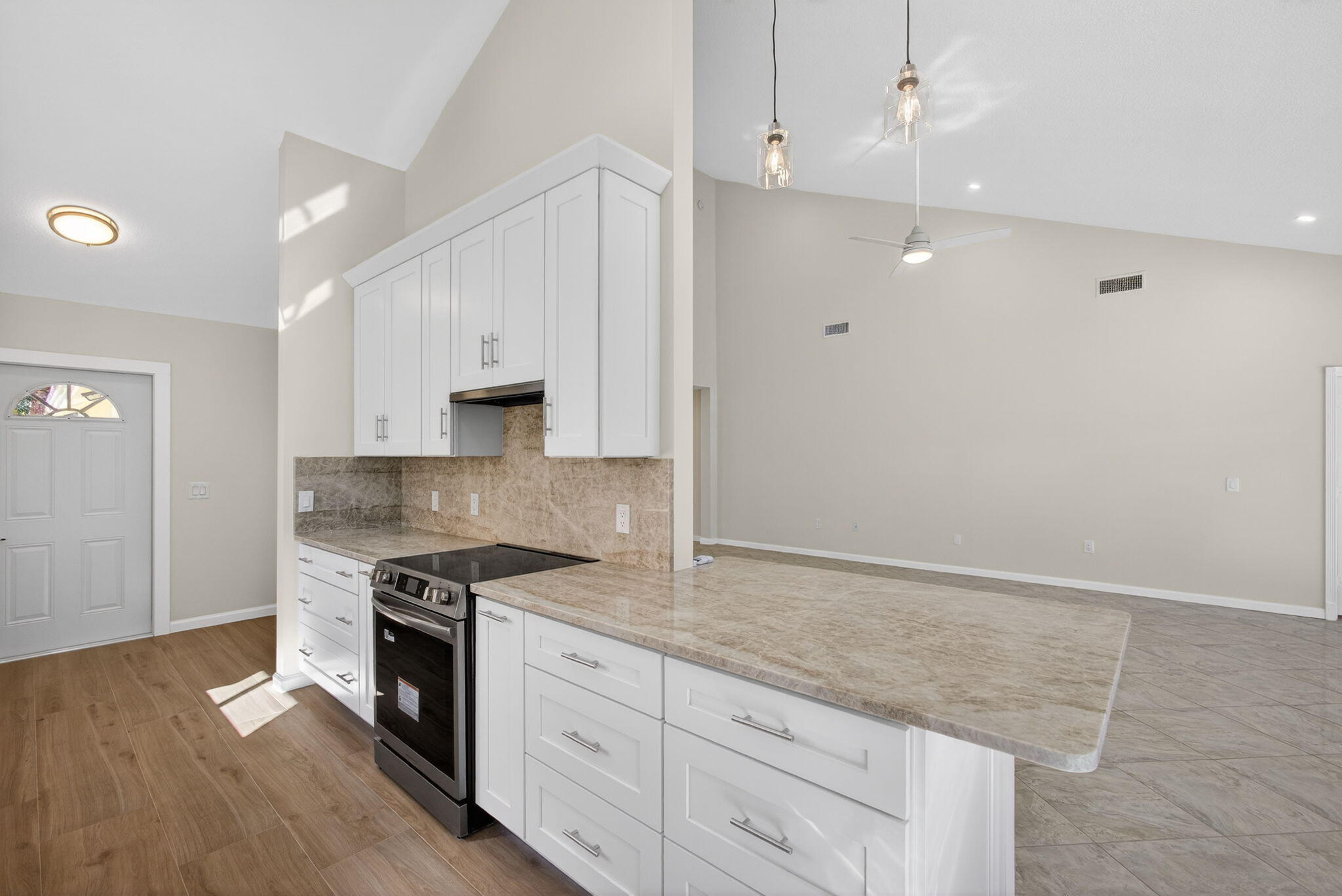 141 Cape Pointe Circle Jupiter, FL 33477 - Photo 7 of 31 a kitchen with granite countertop cabinets stainless steel appliances and a wooden floor
