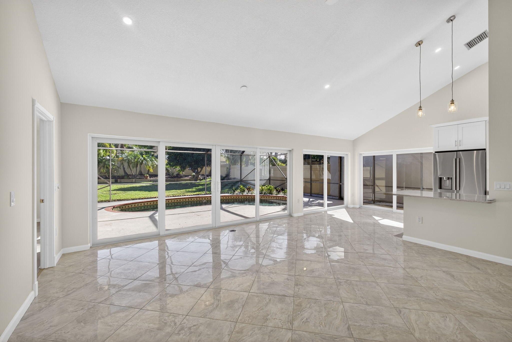 141 Cape Pointe Circle Jupiter, FL 33477 - Photo 10 of 31 a view of an empty room with a sliding door and windows