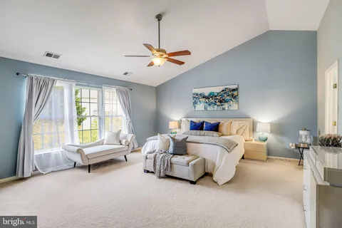 a spacious bedroom with a bed and a couch