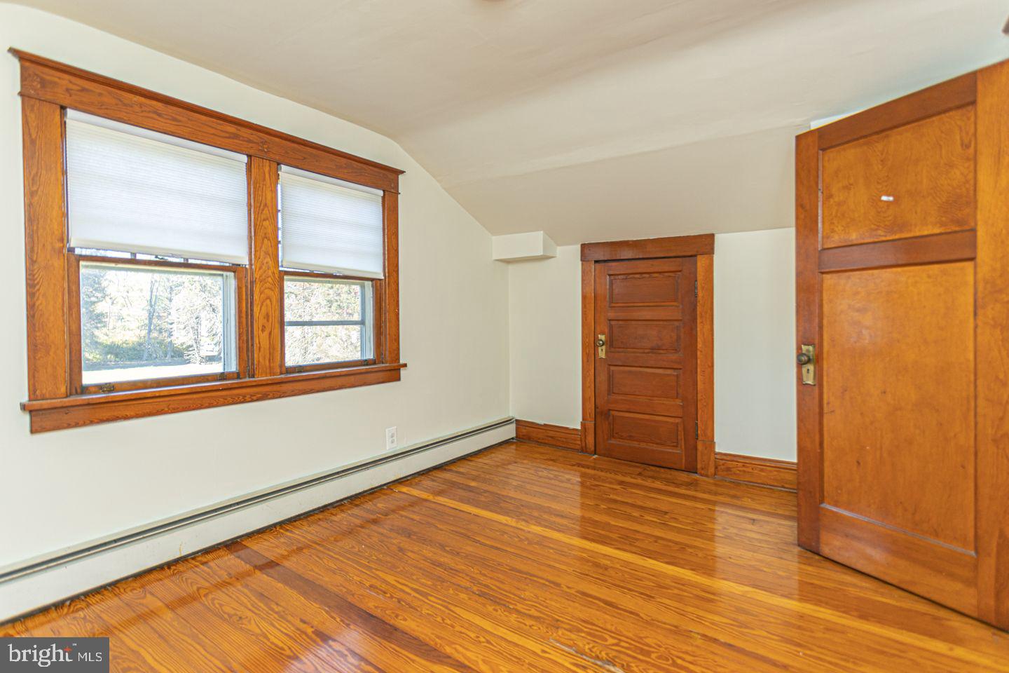 1525 Yardley Newtown Road Yardley, PA 19067 - Photo 11 of 15 an empty room with wooden floor and windows