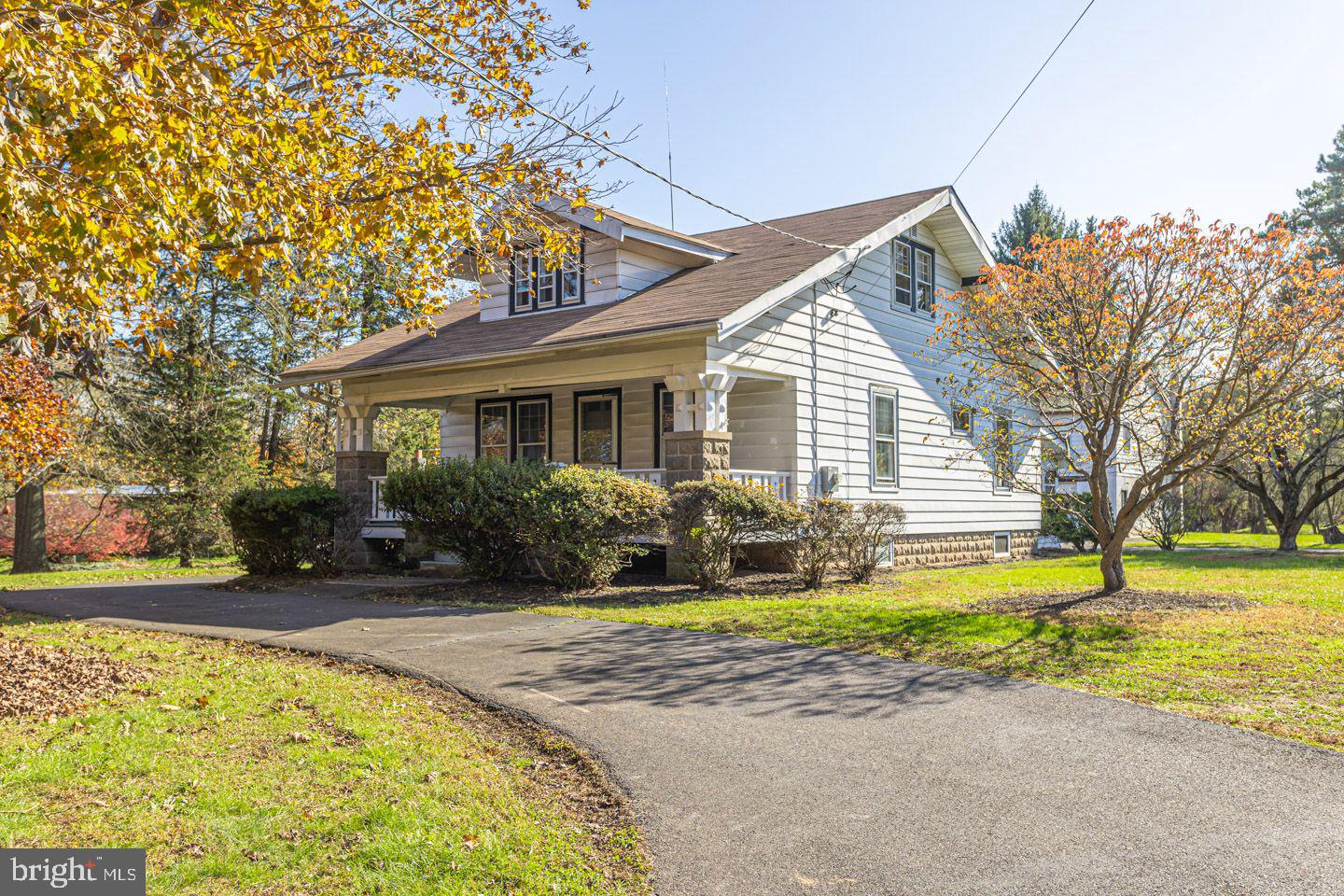 1525 Yardley Newtown Road Yardley, PA 19067 - Photo 2 of 15 a front view of house with swimming pool and green space