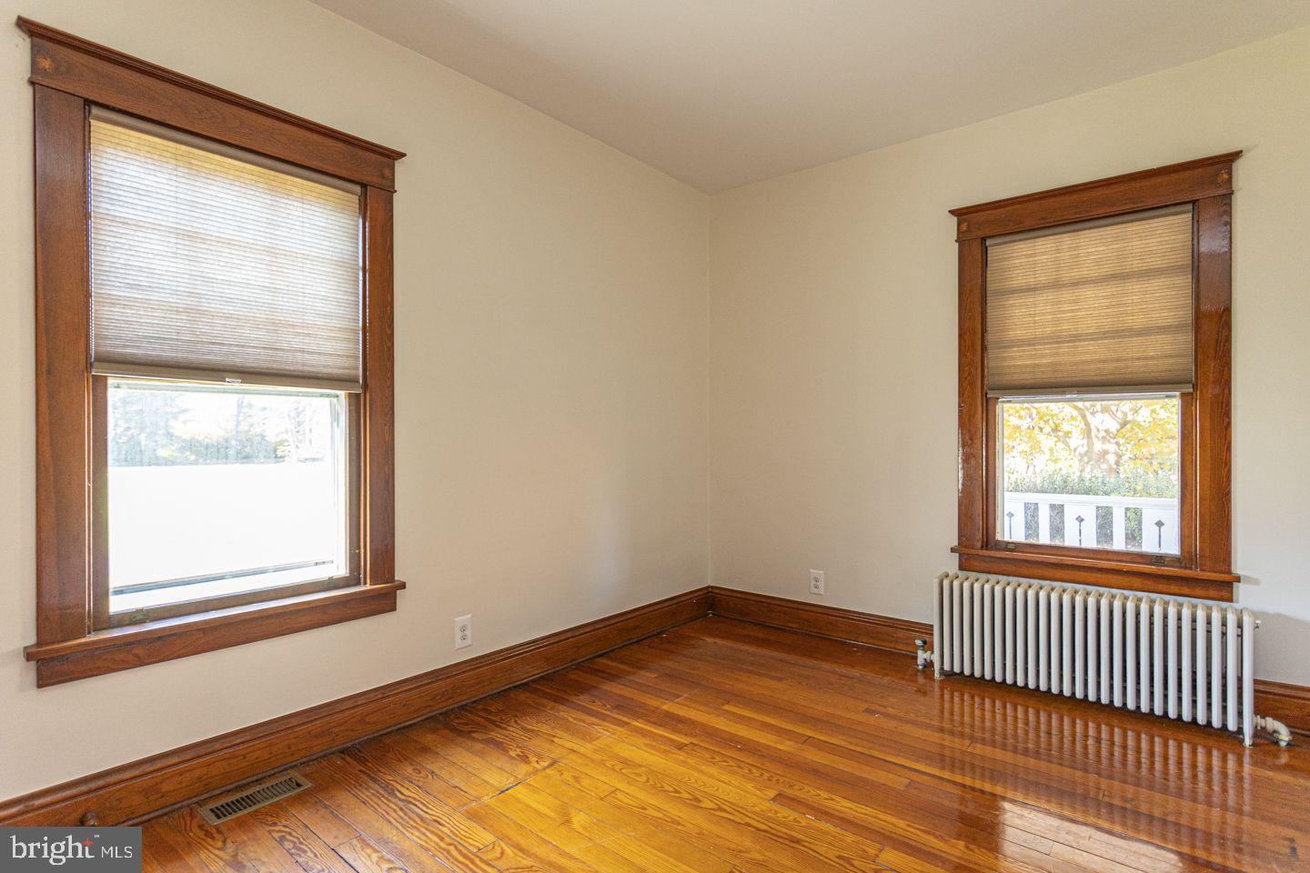 1525 Yardley Newtown Road Yardley, PA 19067 - Photo 9 of 15 an empty room with wooden floor and windows