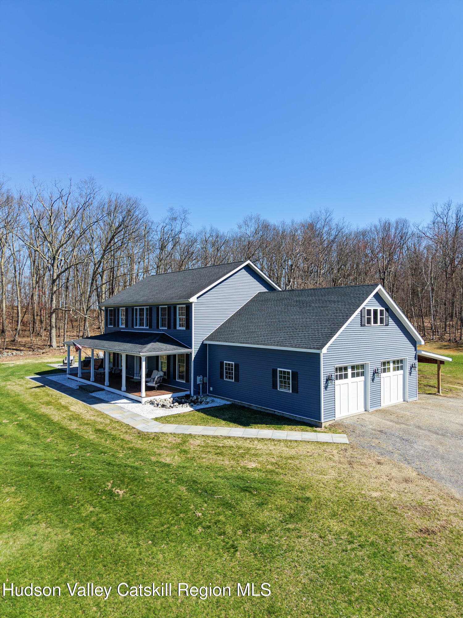 a view of a big house with a big yard and large trees