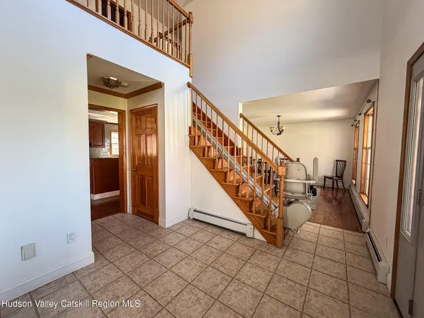 a view of entryway and hall with wooden floor