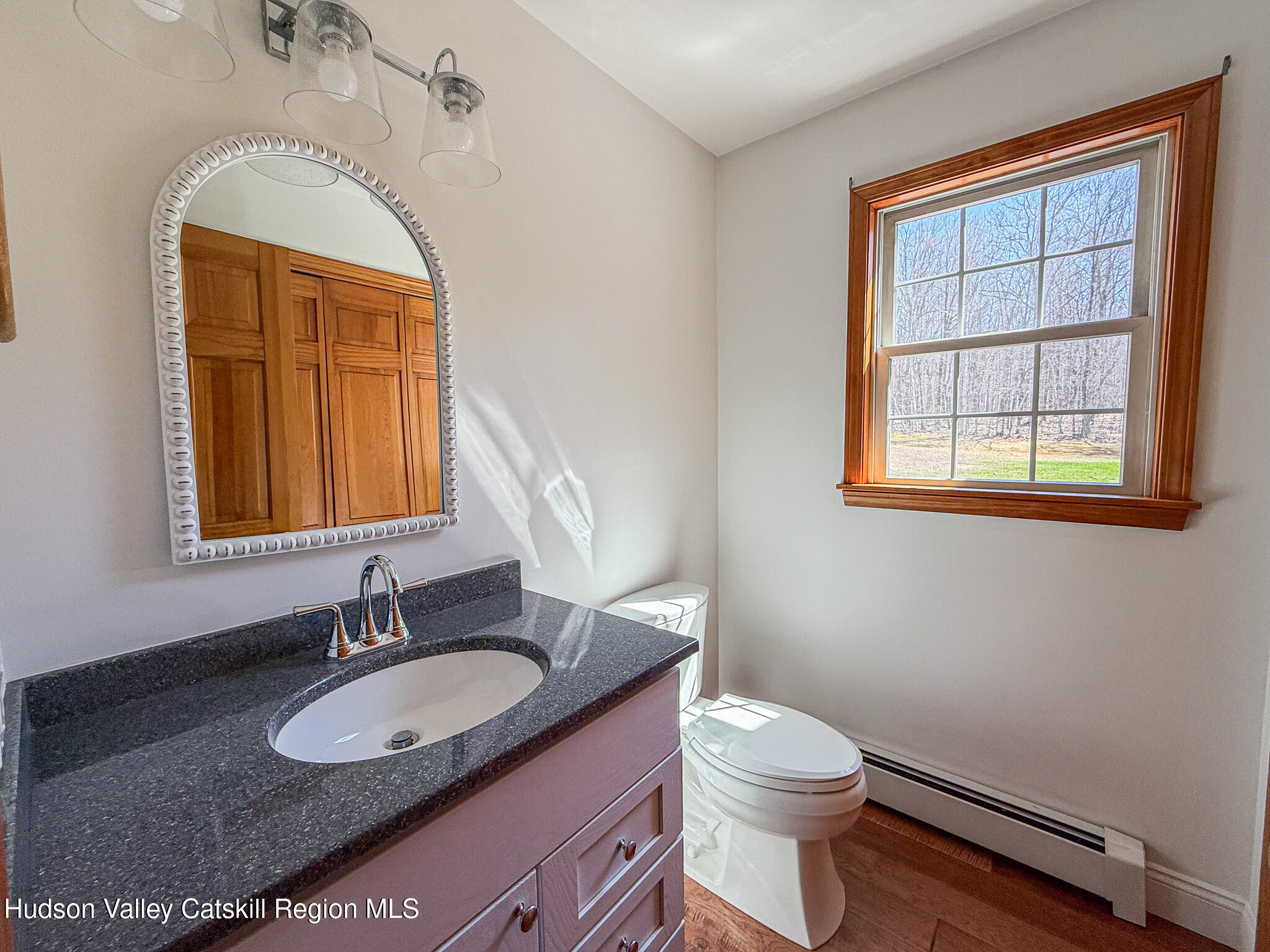 521 Hall Hill Road Ancram, NY 12502 - Photo 17 of 34 a bathroom with a granite countertop sink vanity mirror and toilet