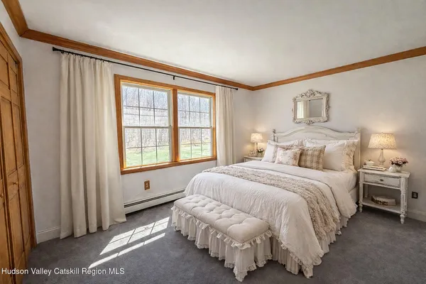 a spacious bedroom with a bed and a window