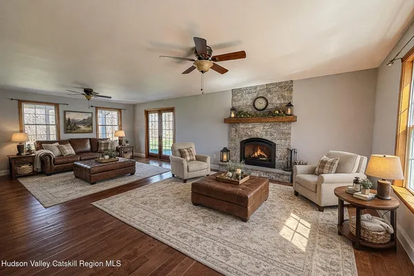 a living room with furniture fireplace and window