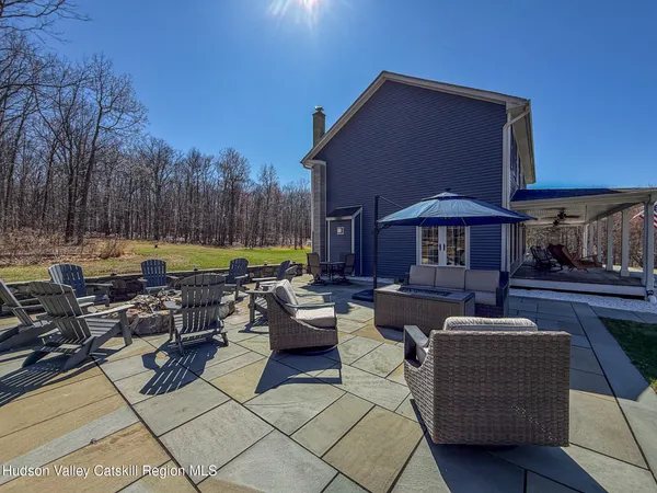 a view of a patio with couches and a fire pit