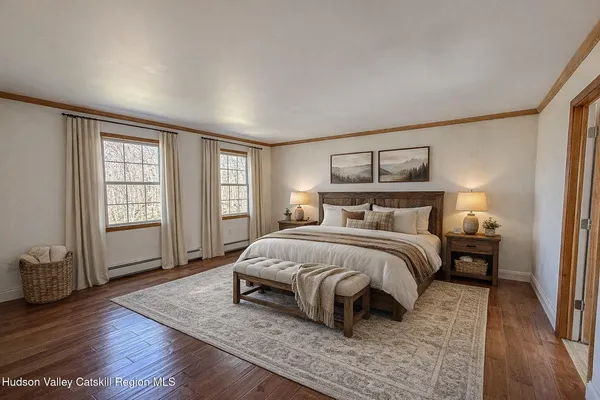 a spacious bedroom with a bed a window and walk in closet