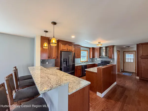 a living room with stainless steel appliances kitchen island granite countertop furniture and a kitchen view