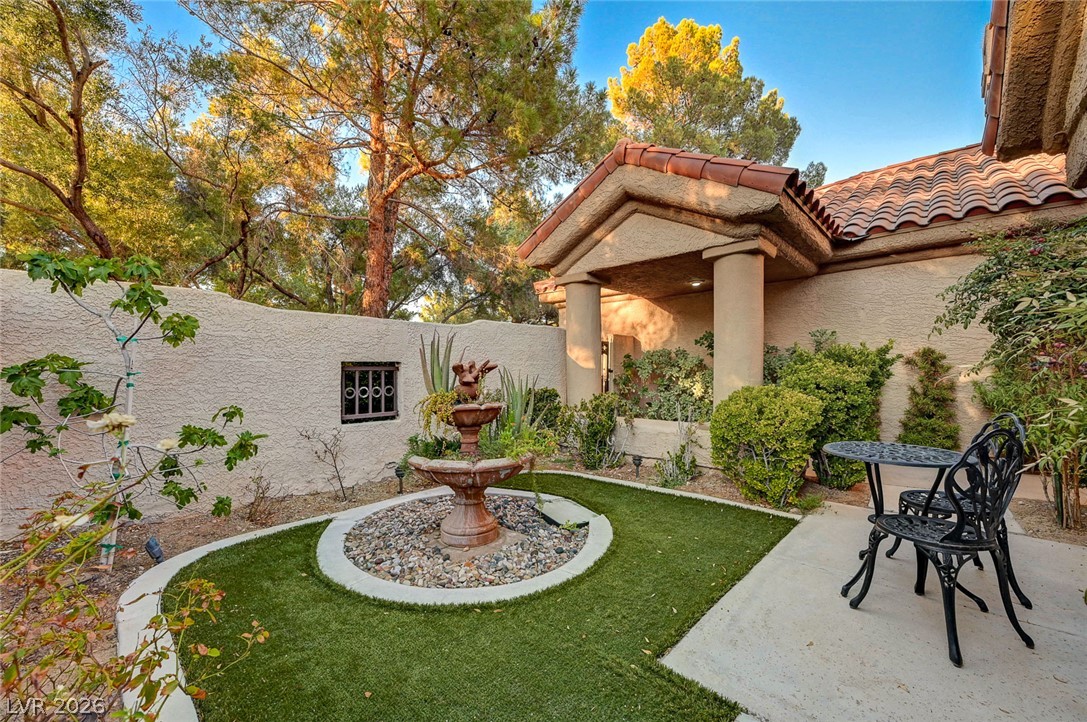 7995 Rio Rico Drive Las Vegas, NV 89113 - Photo 4 of 92 A tranquil courtyard entry welcomes with a tiered fountain and low-maintenance landscaping.