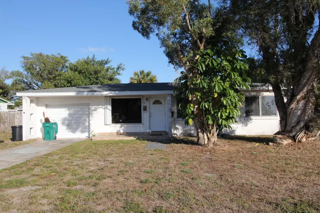 a view of a house with a tree and a yard
