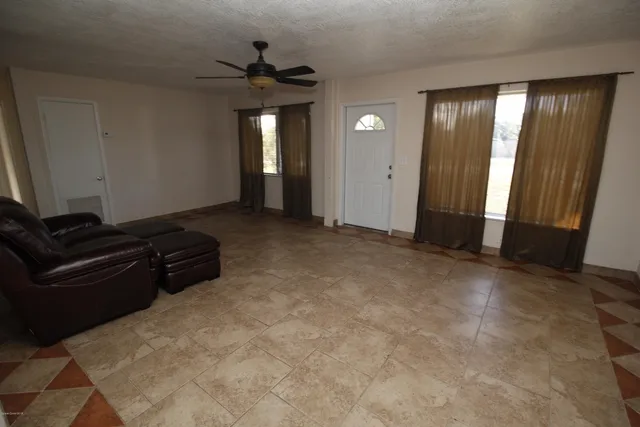 an empty room with closet and windows