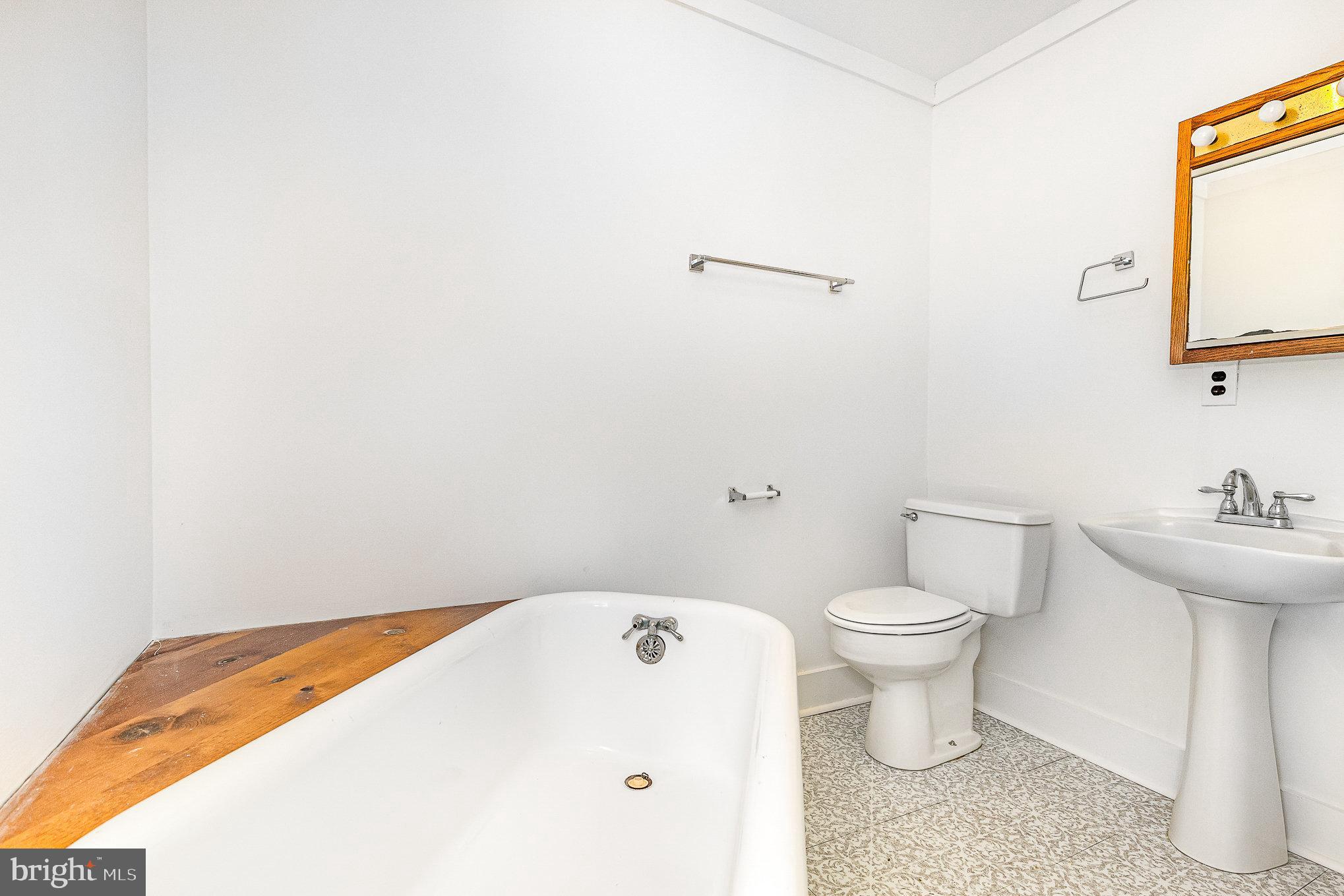 6908 South Roxbury Mill Road Spotsylvania, VA 22551 - Photo 33 of 92 a white toilet sitting next to a bathroom sink