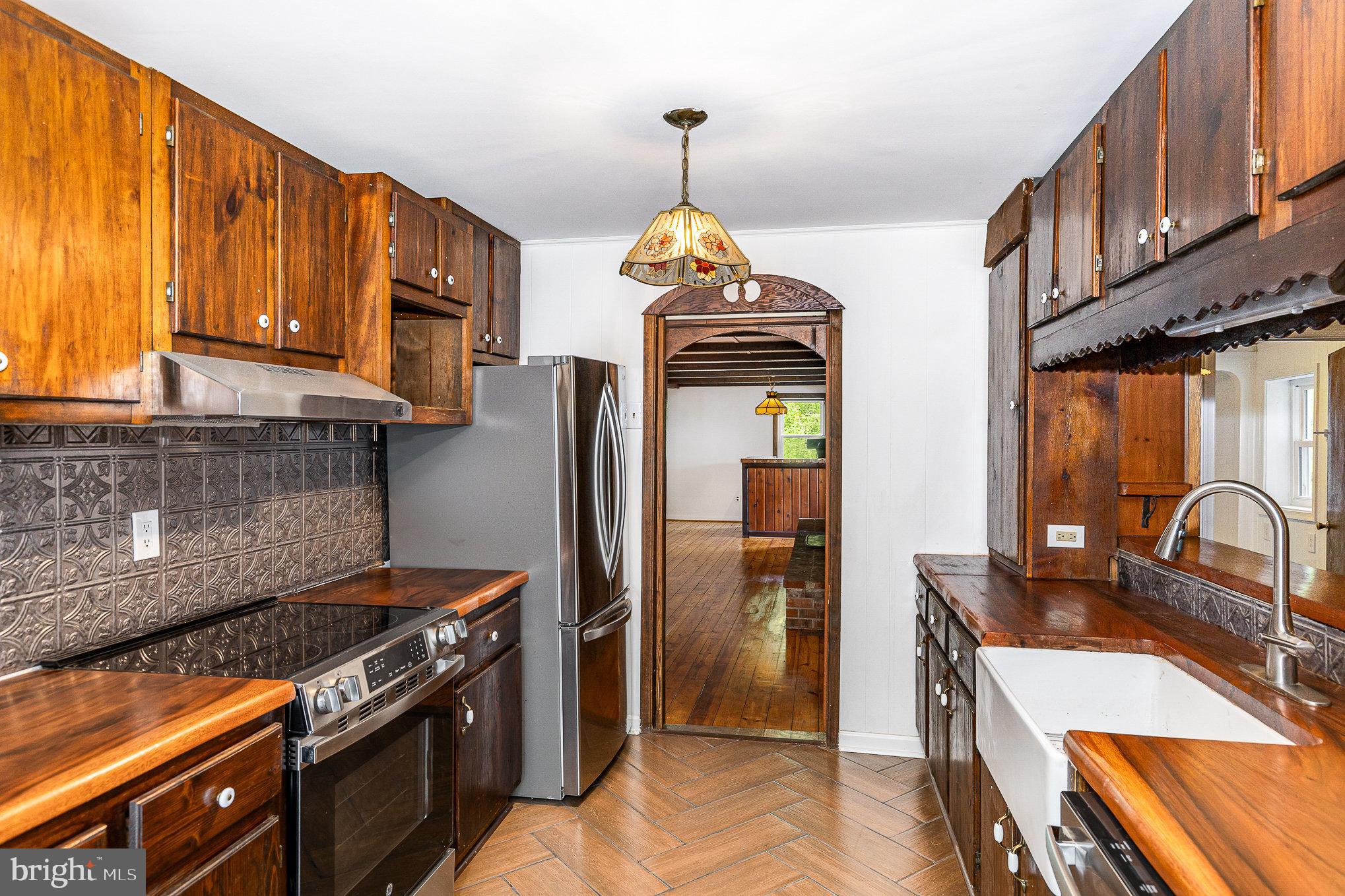 6908 South Roxbury Mill Road Spotsylvania, VA 22551 - Photo 42 of 92 a kitchen with stainless steel appliances granite countertop a stove a sink and a microwave