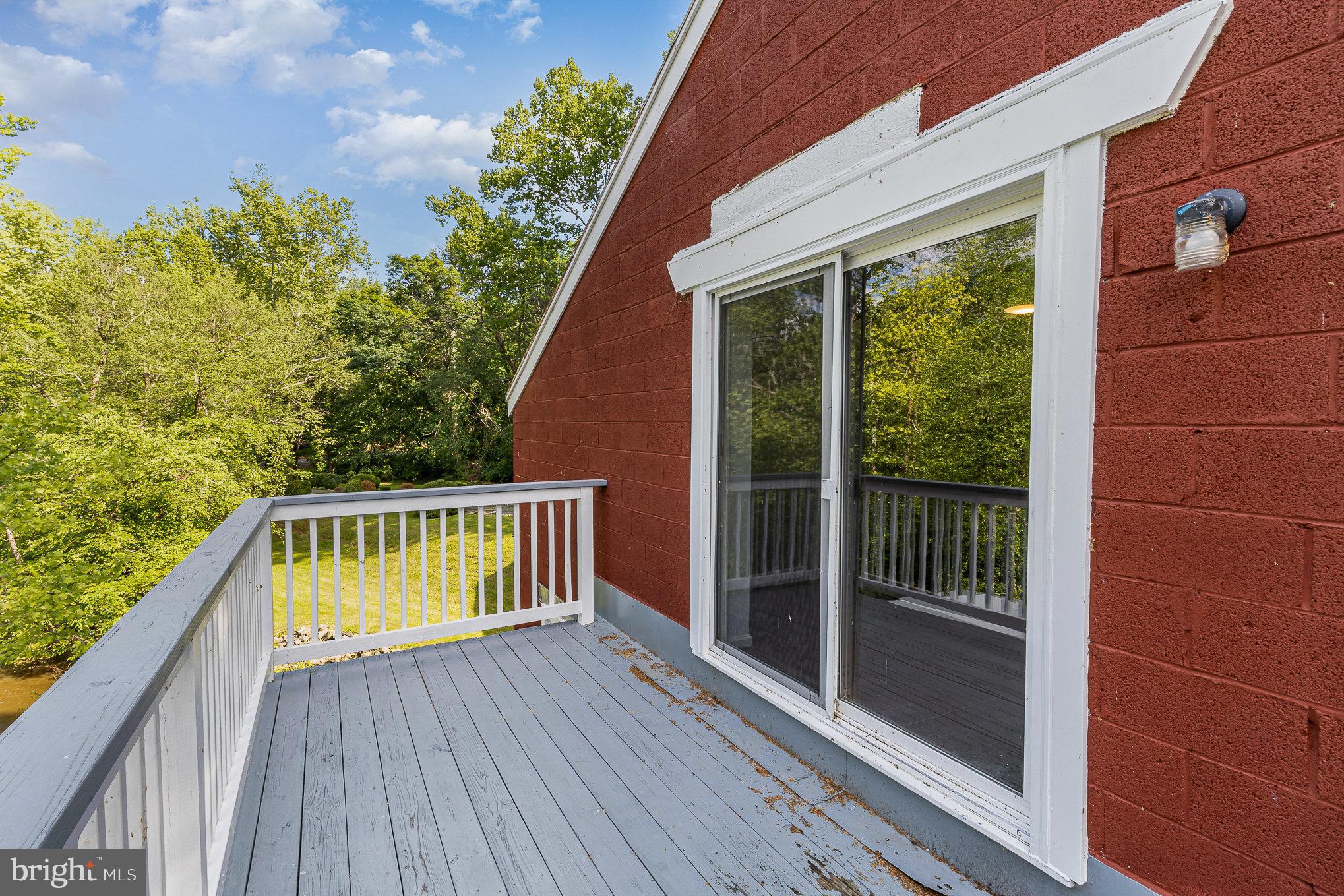 6908 South Roxbury Mill Road Spotsylvania, VA 22551 - Photo 59 of 92 a balcony with wooden floor and yard in the back