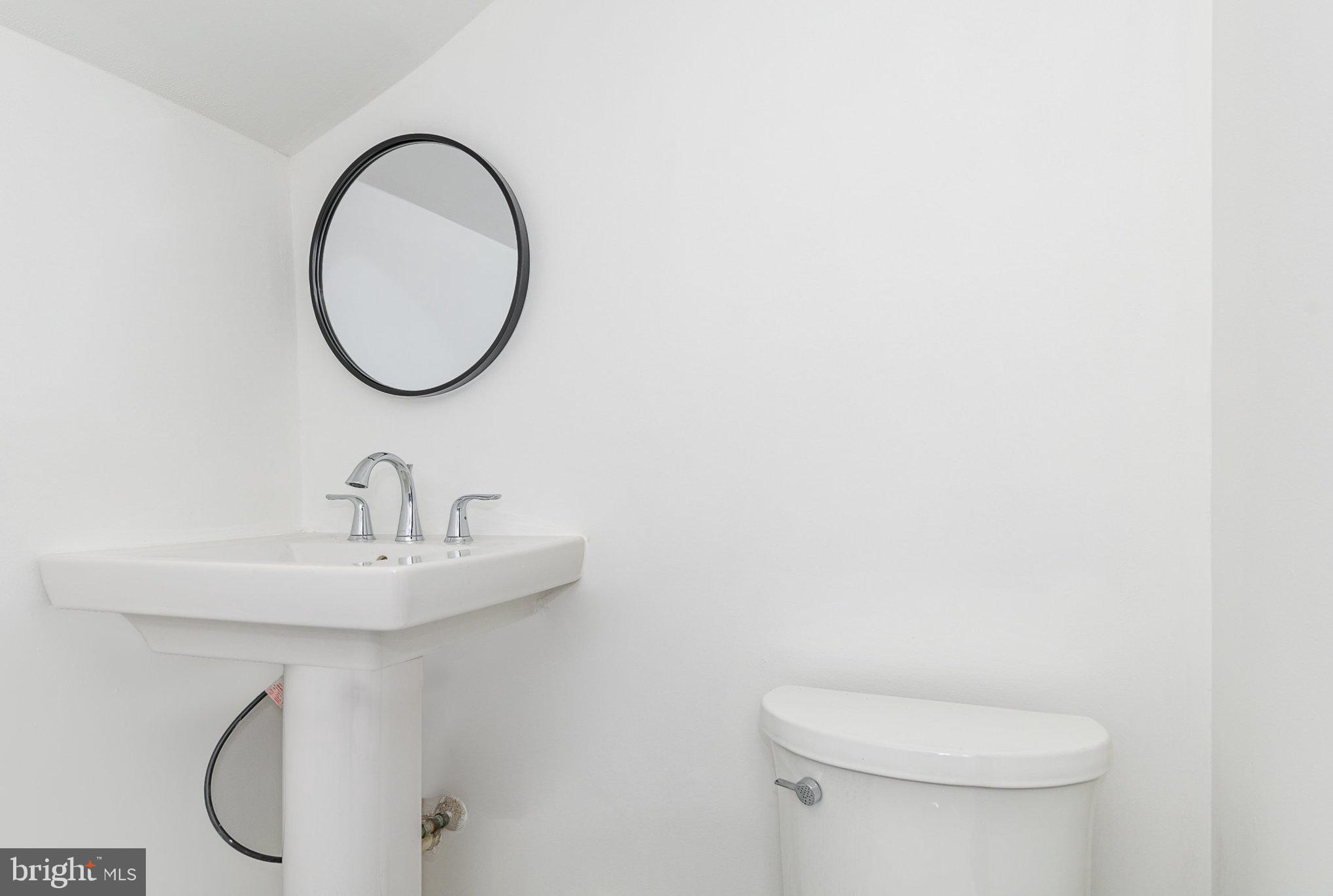 6908 South Roxbury Mill Road Spotsylvania, VA 22551 - Photo 61 of 92 a bathroom with a sink a toilet and a mirror