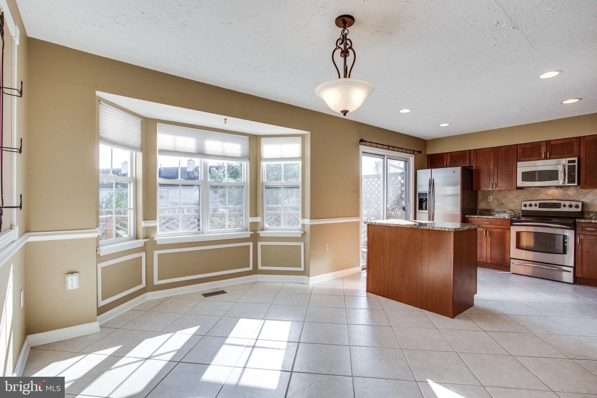 6121 Baldridge Circle Frederick, MD 21701 - Photo 12 of 60 a large kitchen with stainless steel appliances granite countertop a refrigerator and a stove top oven
