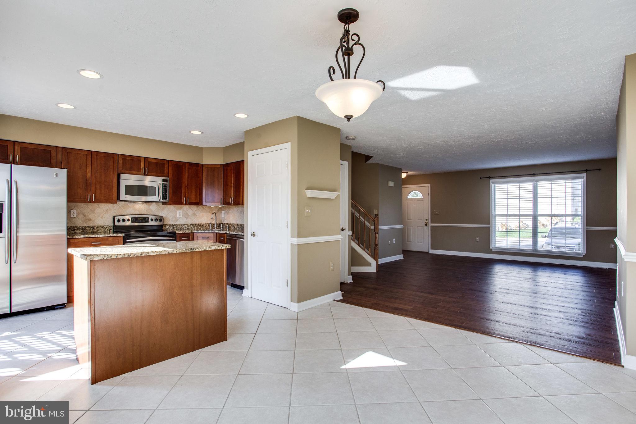 6121 Baldridge Circle Frederick, MD 21701 - Photo 60 of 60 a kitchen with stainless steel appliances granite countertop a refrigerator and a sink