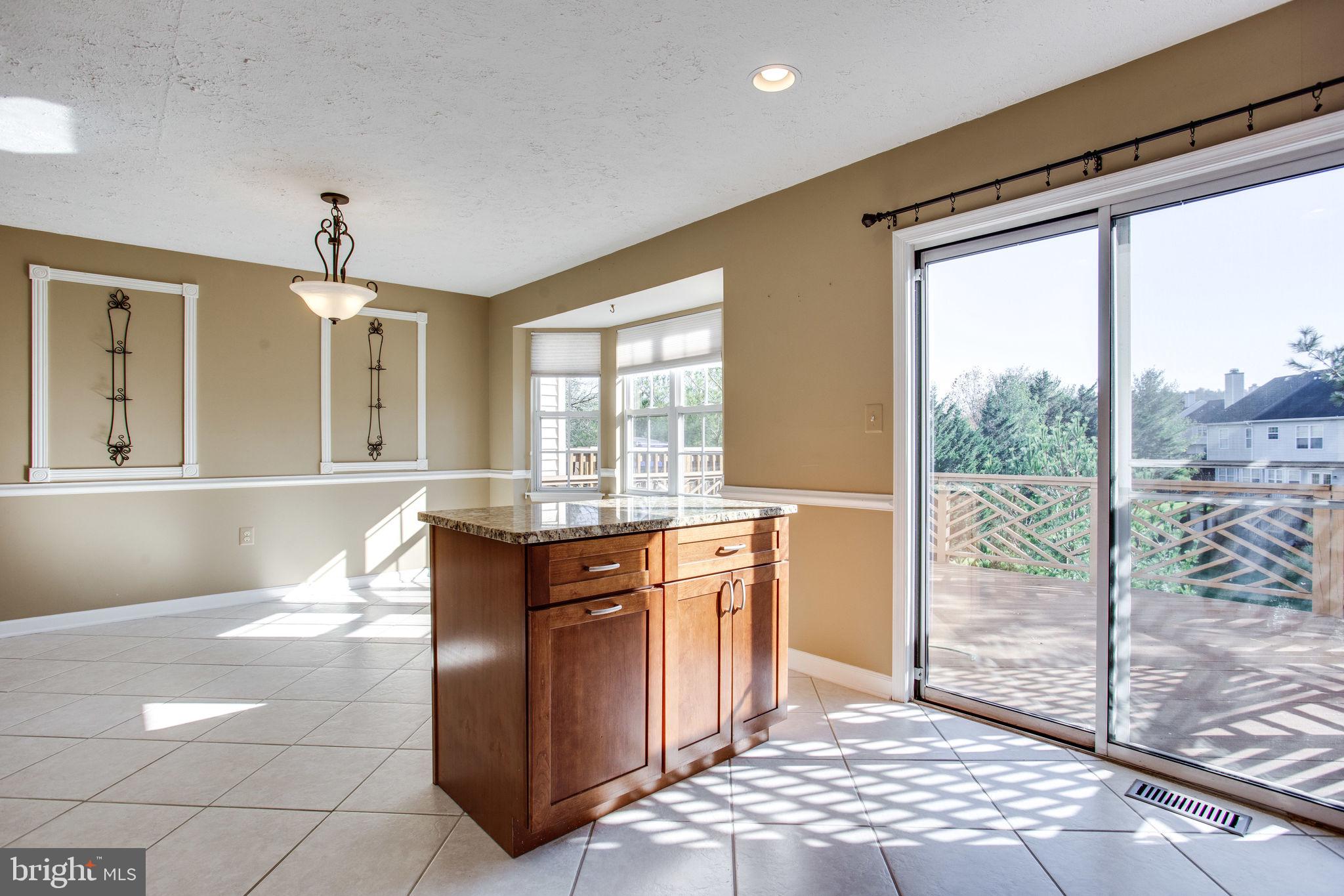 6121 Baldridge Circle Frederick, MD 21701 - Photo 14 of 60 a spacious bathroom with a granite countertop sink and a mirror
