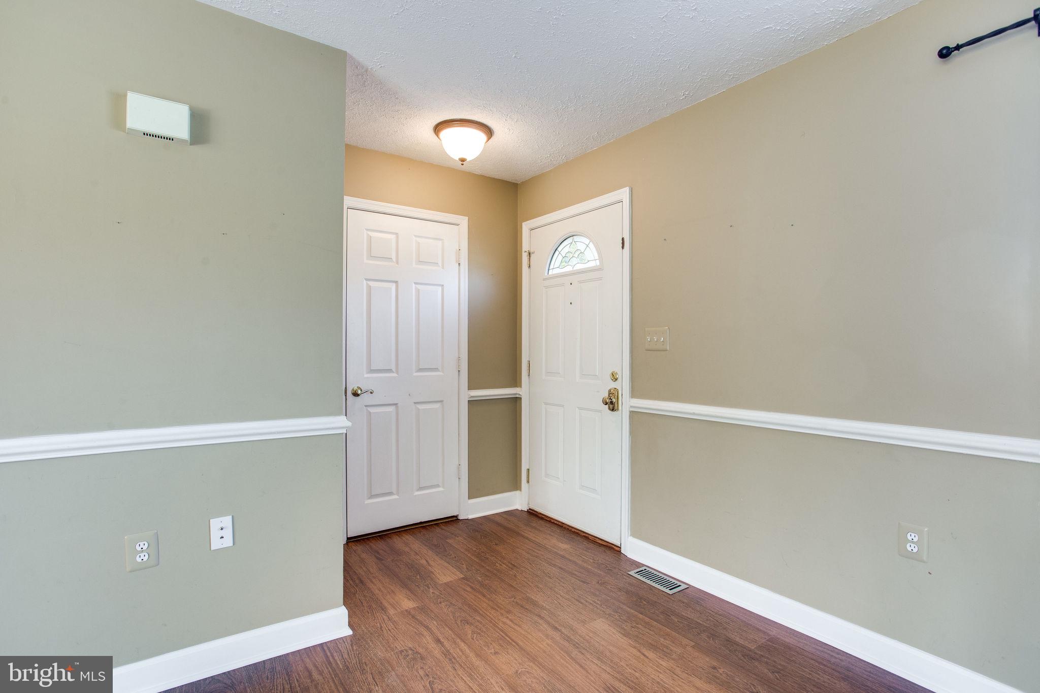 6121 Baldridge Circle Frederick, MD 21701 - Photo 3 of 60 an empty room with wooden floor and windows