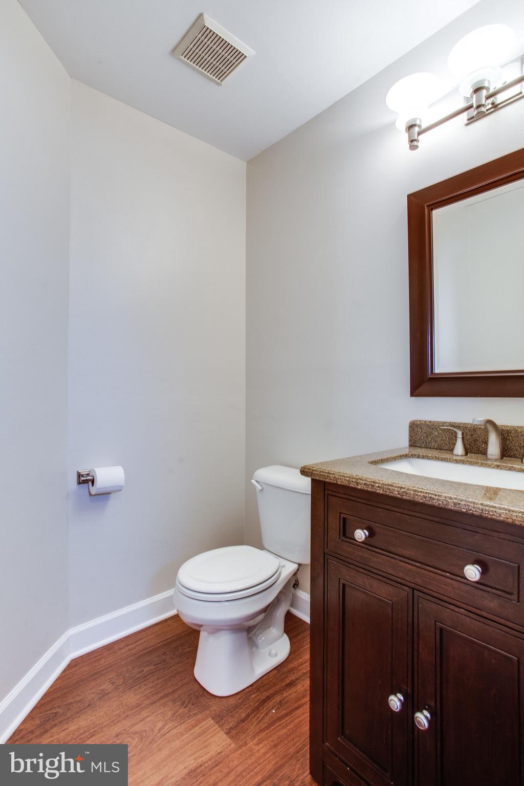 6121 Baldridge Circle Frederick, MD 21701 - Photo 27 of 60 a bathroom with a granite countertop toilet a sink and mirror