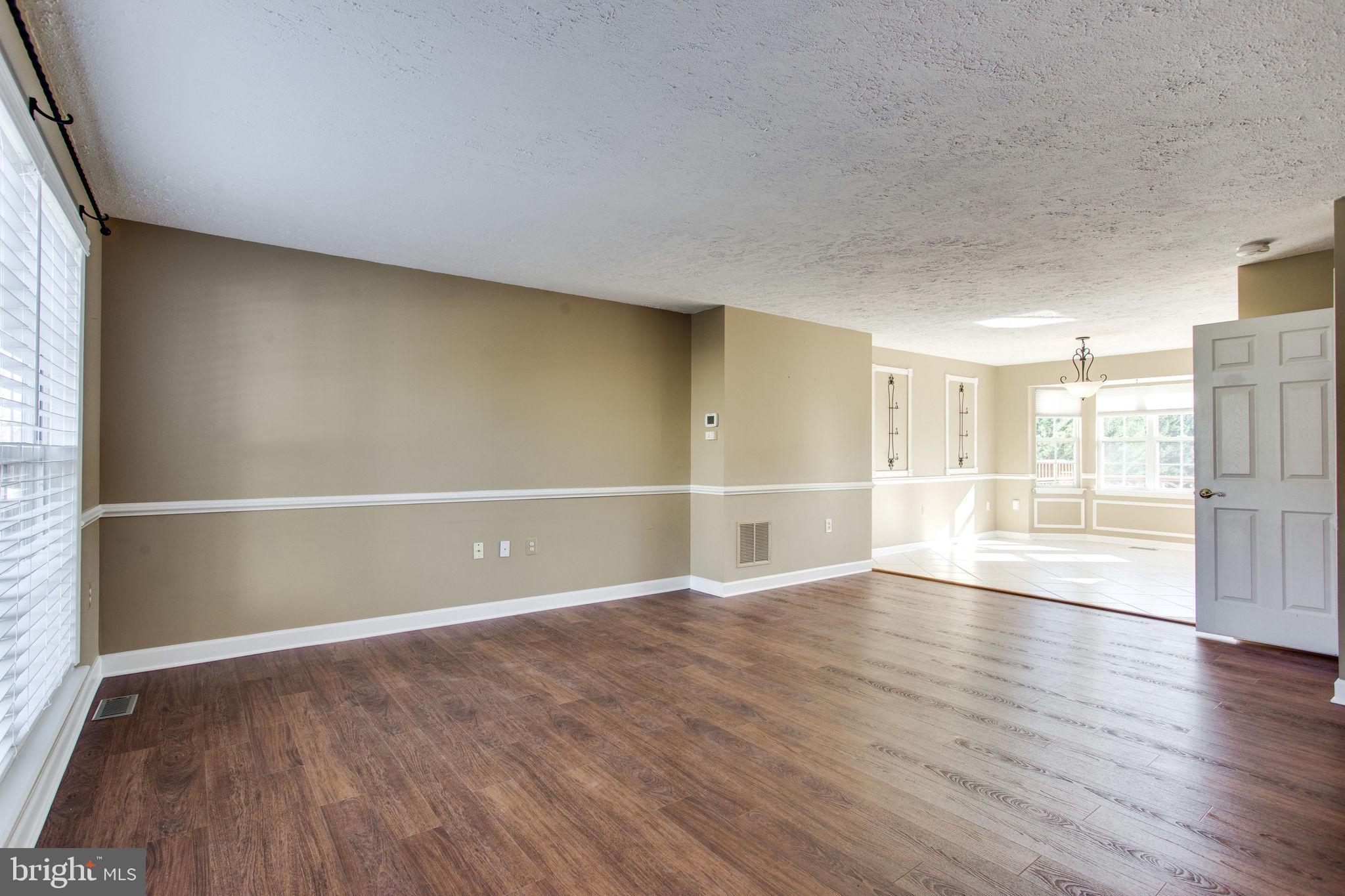 6121 Baldridge Circle Frederick, MD 21701 - Photo 4 of 60 a view of empty room with wooden floor