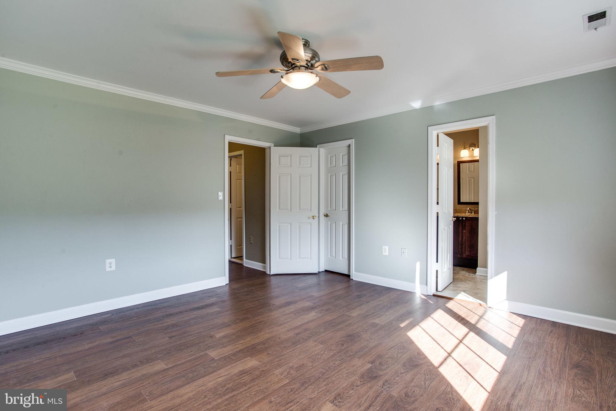 6121 Baldridge Circle Frederick, MD 21701 - Photo 30 of 60 an empty room with wooden floor and a ceiling fan