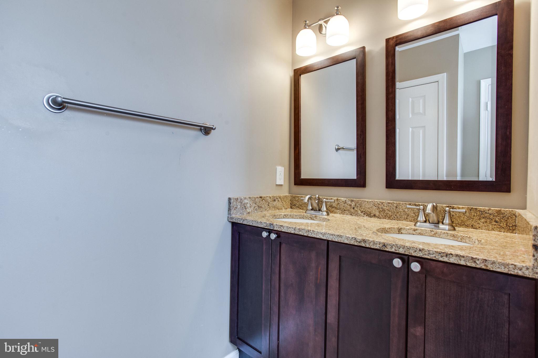 6121 Baldridge Circle Frederick, MD 21701 - Photo 32 of 60 a bathroom with a double vanity sink and a mirror