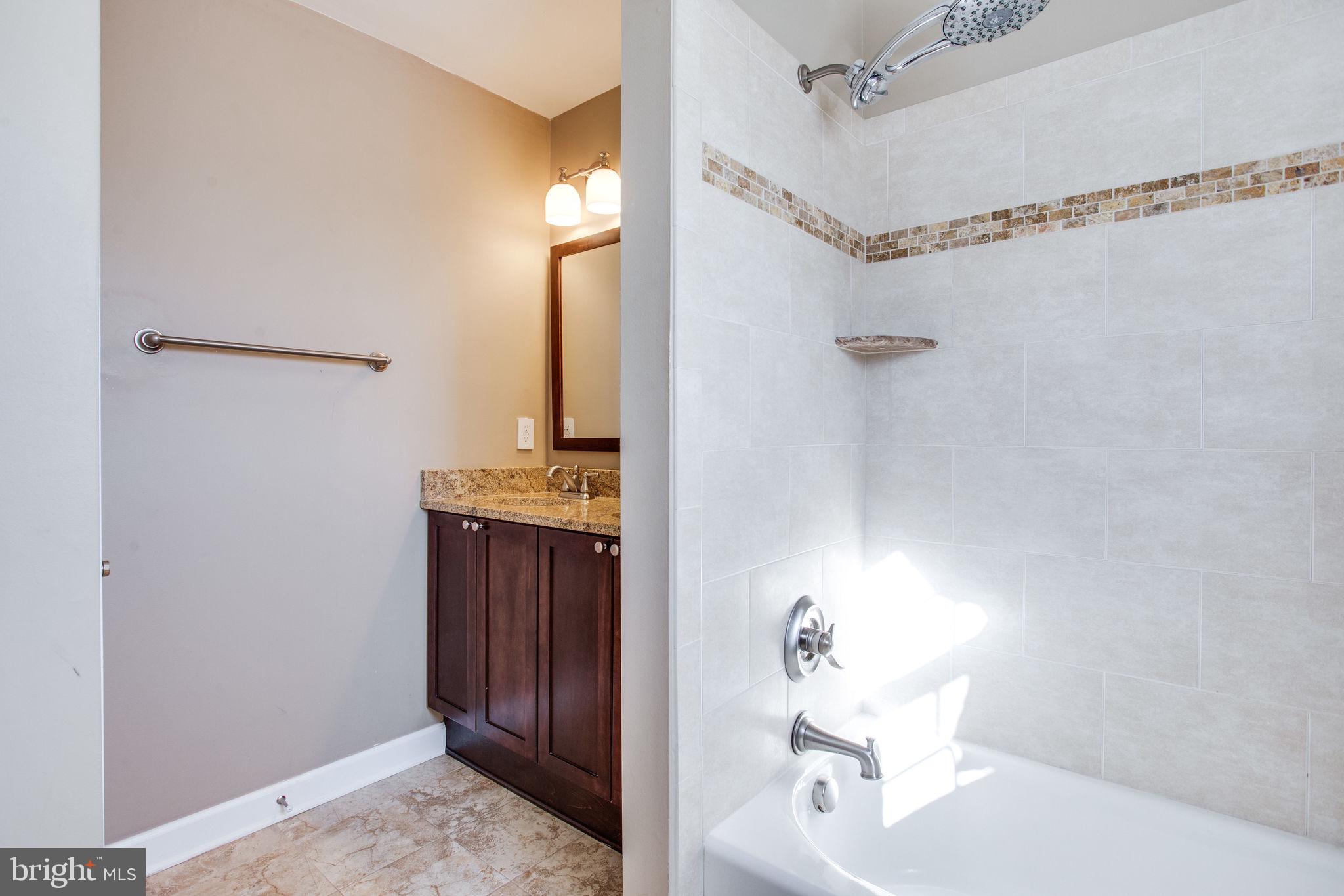 6121 Baldridge Circle Frederick, MD 21701 - Photo 33 of 60 a bathroom with a sink a vanity and shower